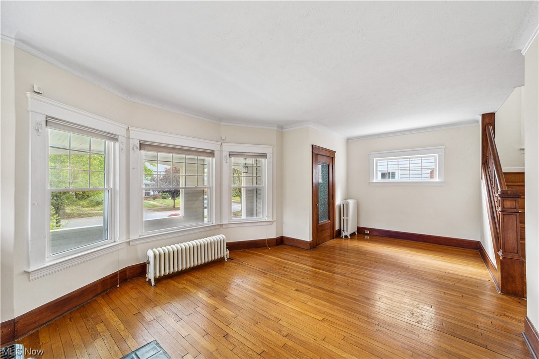 3045 East Overlook Road Cleveland, OH 44118 - Photo 5 of 29 Living room featuring a wealth of natural light, light wood-type flooring, and radiator