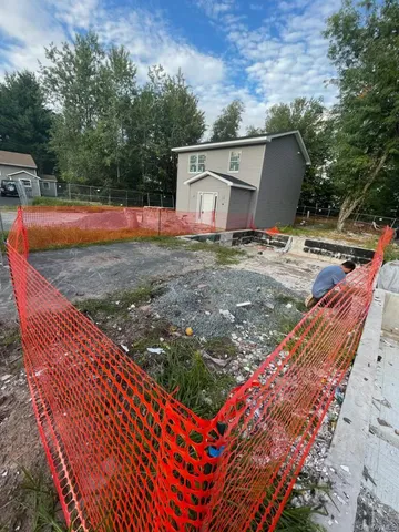 a view of a backyard with swimming pool