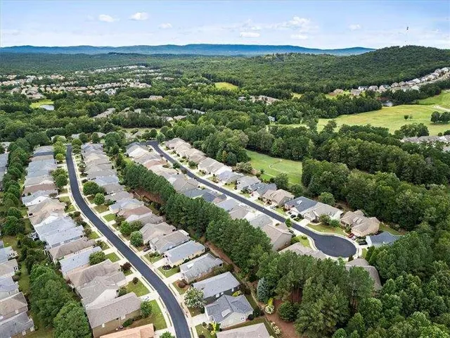 a balcony with wooden floor and outdoor seating