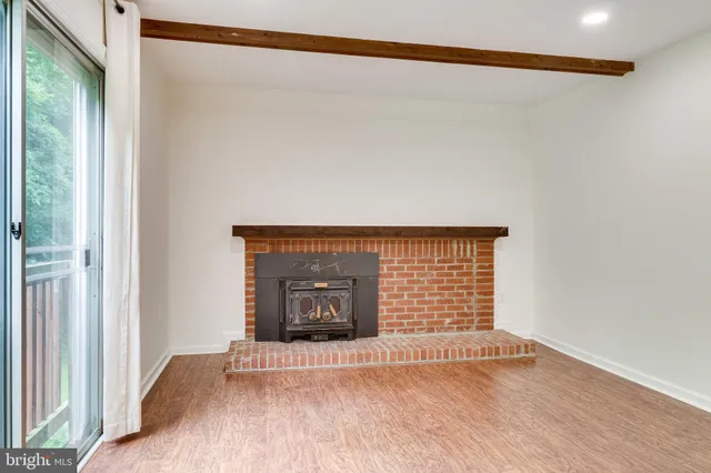 a kitchen with stainless steel appliances granite countertop a sink stove refrigerator and cabinets