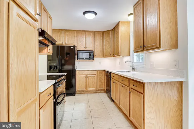a kitchen with stainless steel appliances granite countertop a stove and a sink