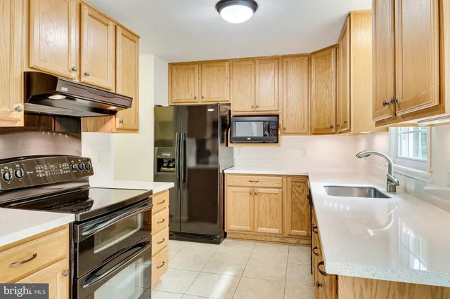 a kitchen with stainless steel appliances granite countertop a sink and a cabinets