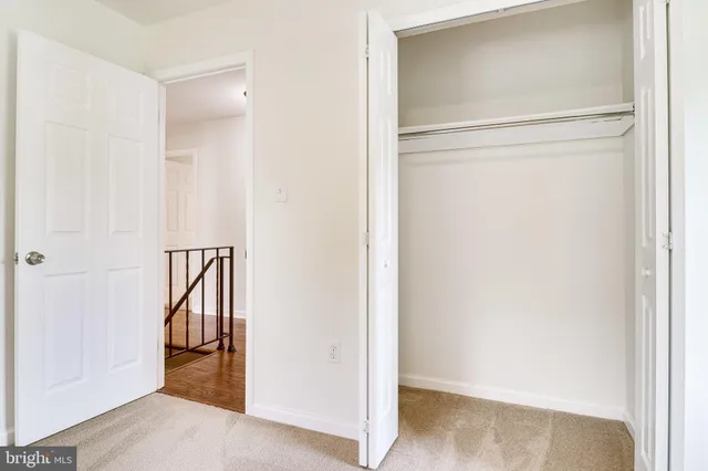 a view of an empty room and wooden floor