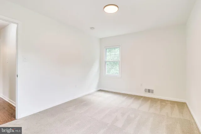 a view of walk in closet with wooden floor