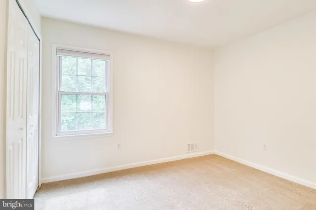a bathroom with a sink mirror and a window