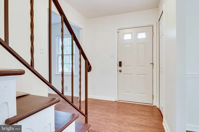 a view of empty room with windows and wooden floor