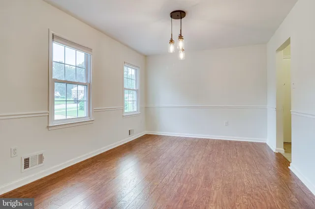 a view of an entryway with wooden floor and a window