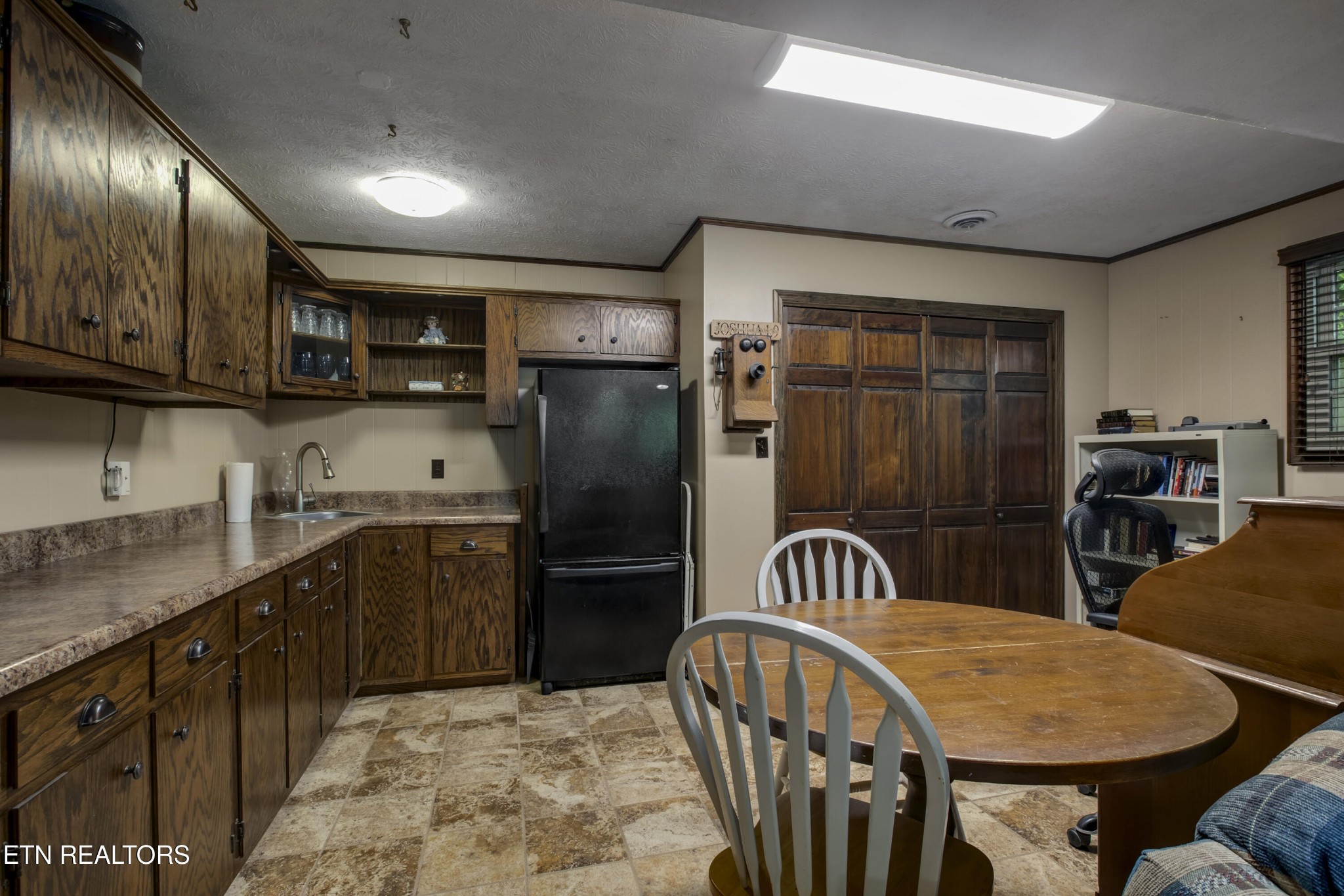 116 Mohawk Road Oak Ridge, TN 37830 - Photo 39 of 60 a kitchen with stainless steel appliances kitchen island granite countertop a refrigerator a sink a stove a dining table and chairs