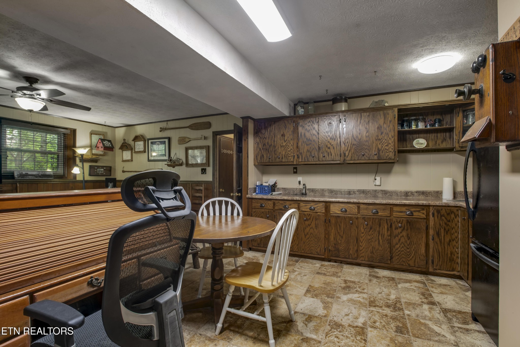 116 Mohawk Road Oak Ridge, TN 37830 - Photo 41 of 60 a kitchen with stainless steel appliances granite countertop a sink a stove a dining table and chairs with wooden floor