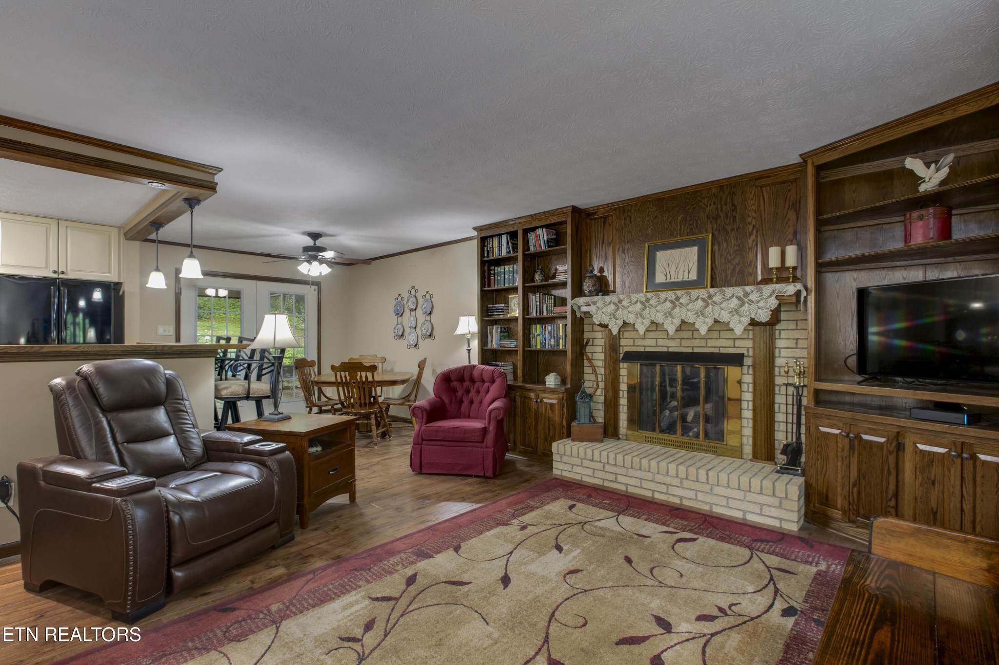 116 Mohawk Road Oak Ridge, TN 37830 - Photo 8 of 60 a living room with furniture a flat screen tv and a fireplace