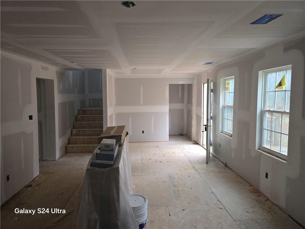 2292 Holly Springs Road Rockmart, GA 30153 - Photo 12 of 21 a view of a hallway to an empty room with wooden floor and windows