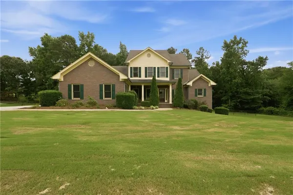 a front view of a house with a garden