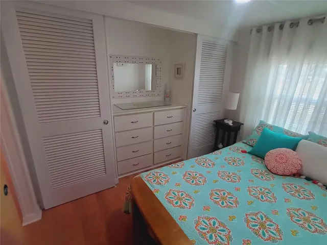 a bedroom with a bed and a mirror
