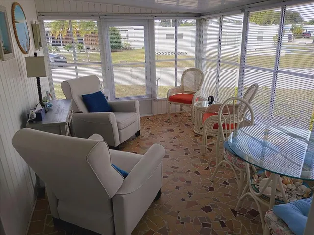 a living room with furniture a rug and a flat screen tv