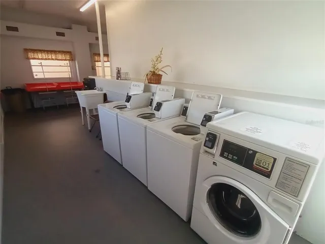 a view of a patio with a table and chairs