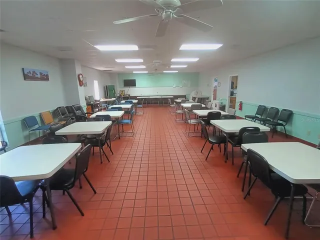 a dining room with furniture and a floor to ceiling window