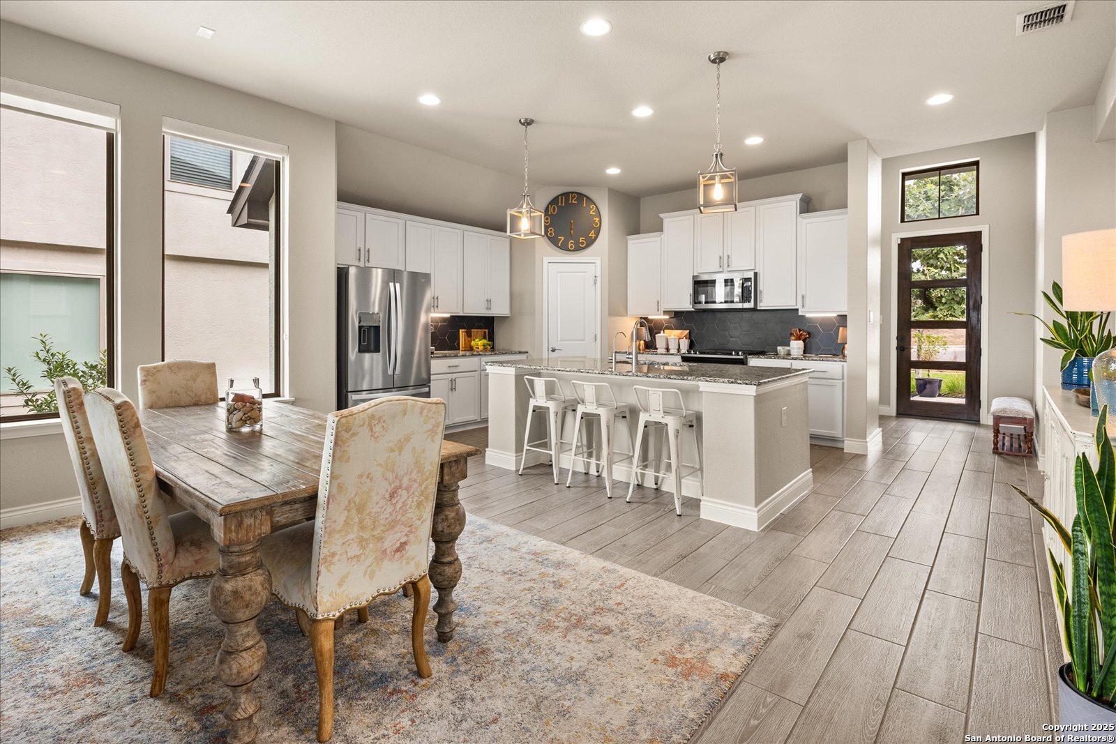 126 Ocotillo Boerne, TX 78006 - Photo 16 of 47 a kitchen with stainless steel appliances kitchen island granite countertop a stove a sink a dining table and chairs
