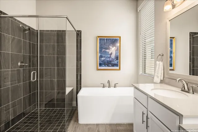 a bathroom with a shower sink and mirror