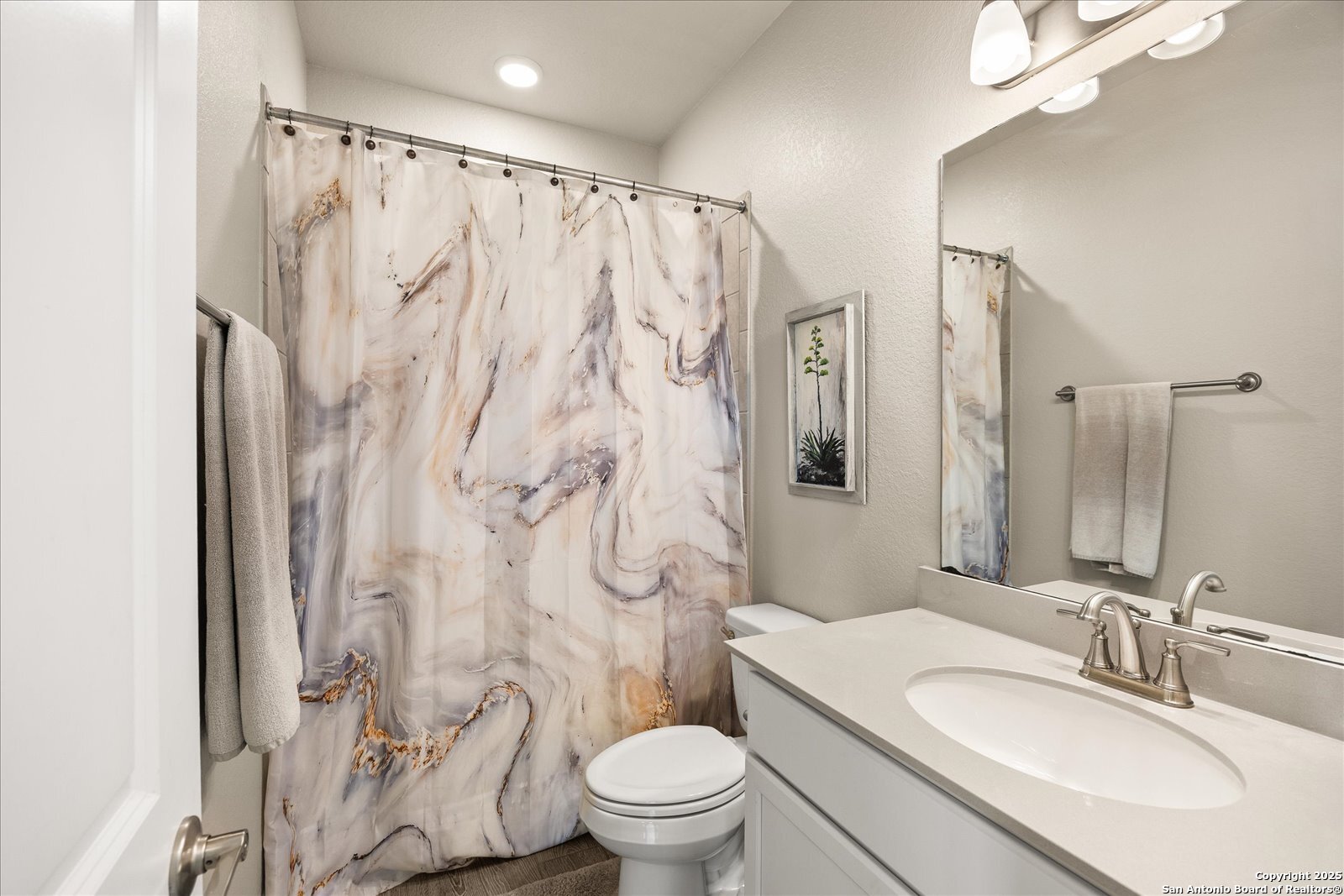 126 Ocotillo Boerne, TX 78006 - Photo 29 of 47 a bathroom with a granite countertop sink a toilet and a mirror