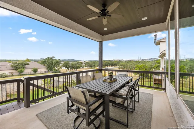 a view of a balcony with furniture and a floor to ceiling window