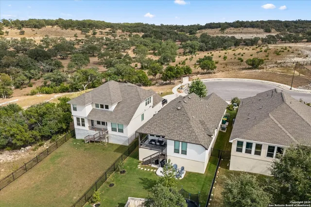 an aerial view of multiple houses with a yard
