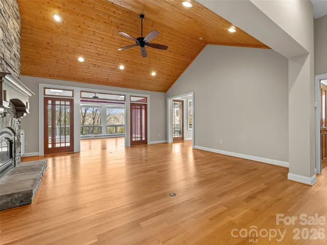 a view of empty room with wooden floor