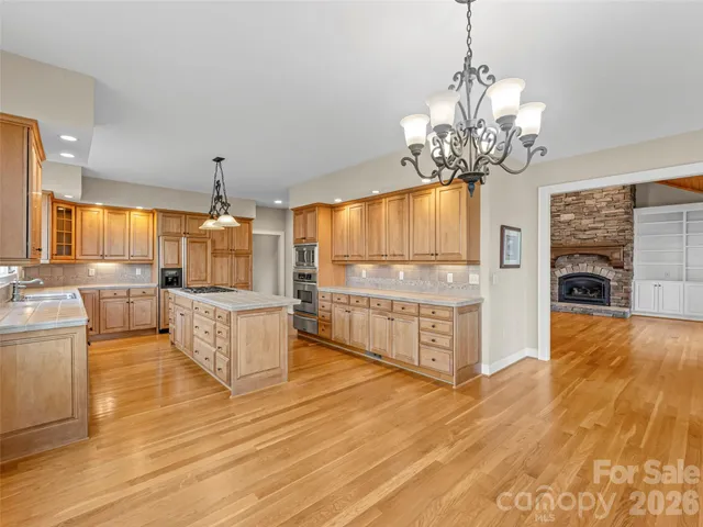 a kitchen with stainless steel appliances granite countertop a stove and a sink