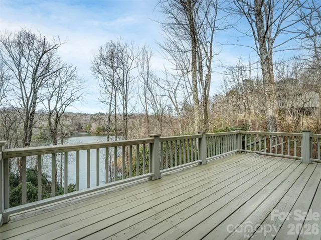 a view of a porch with furniture and wooden floor