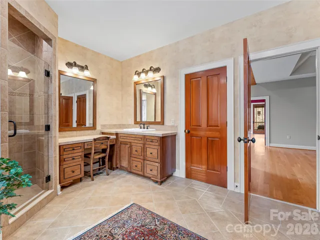 a spacious bedroom with a large bed and a potted plant