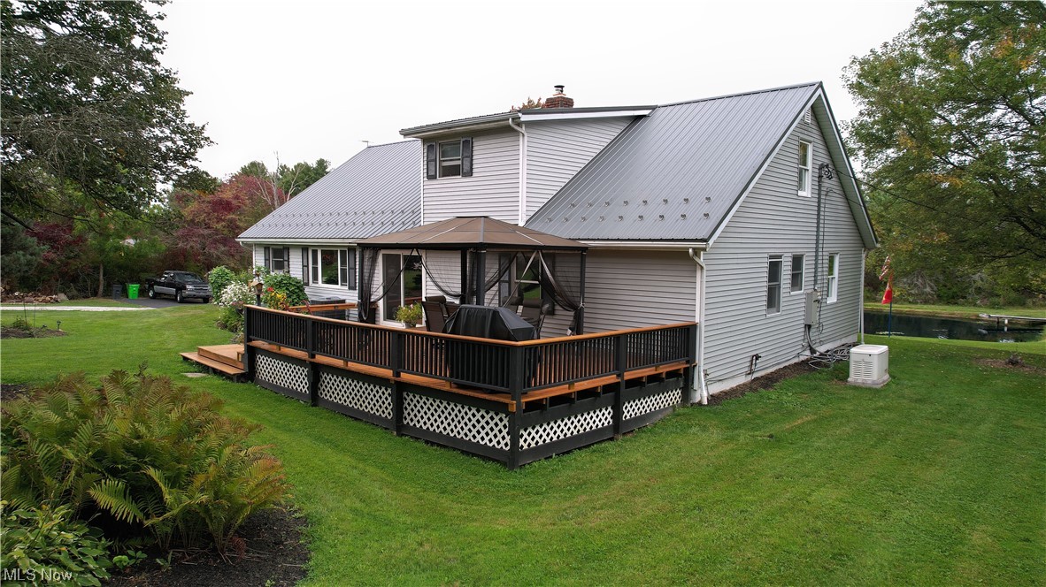 5712 Winchell Road Hiram, OH 44234 - Photo 9 of 31 Back of house with central AC, a lawn, and a deck