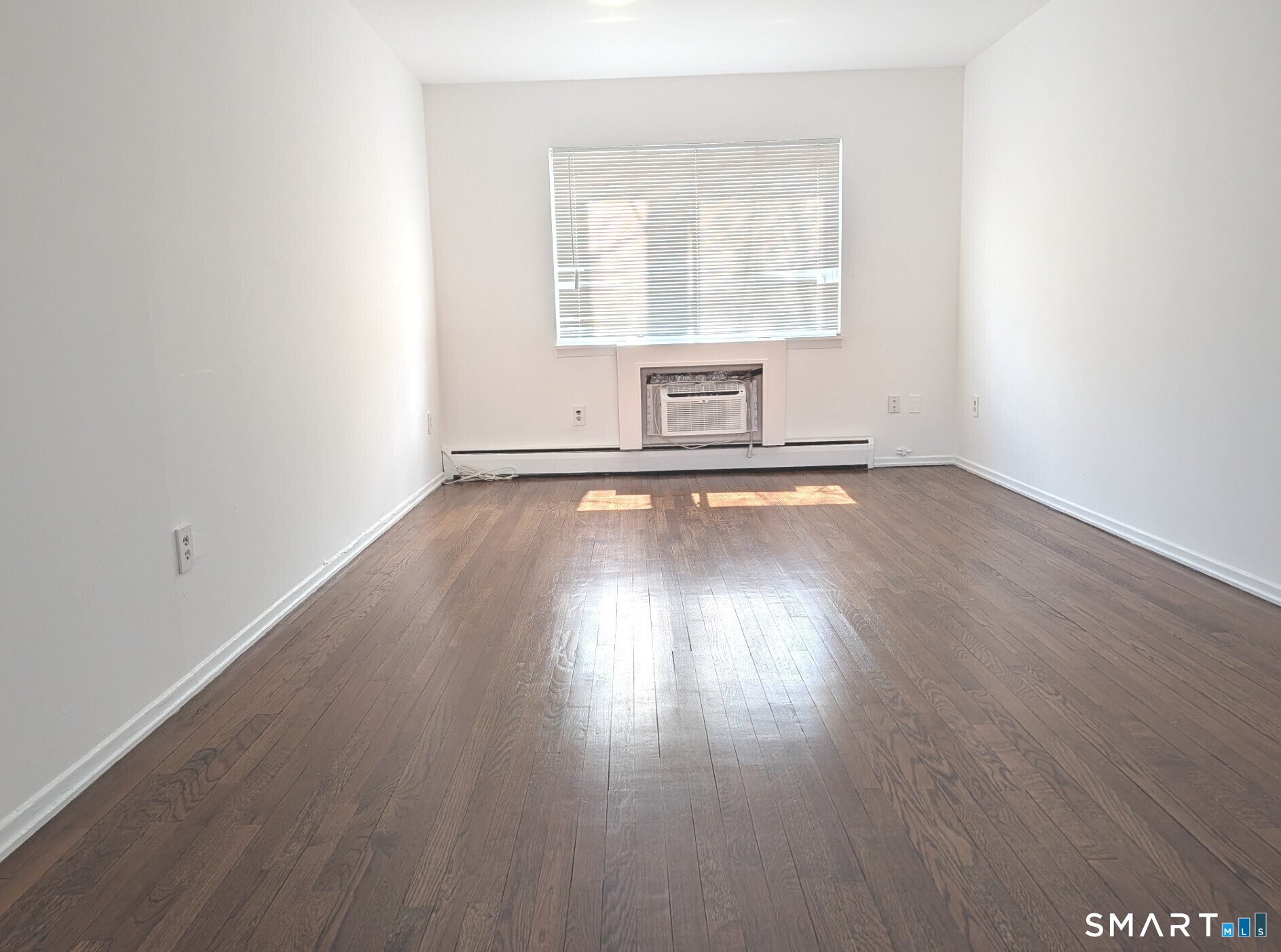 18 Prospect Street, Unit C10 Norwalk, CT 06850 - Photo 2 of 11 an empty room with wooden floor and windows
