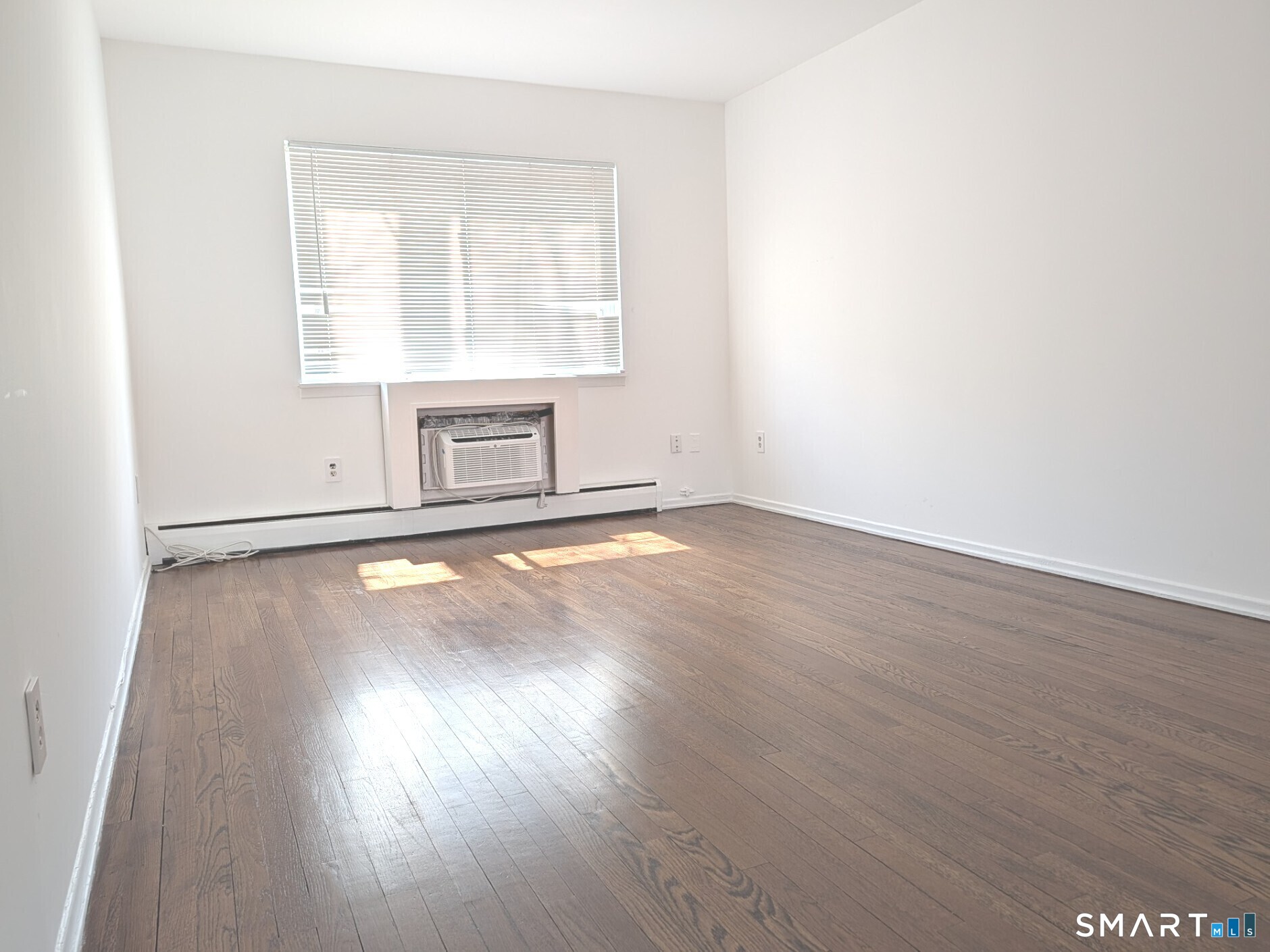 18 Prospect Street, Unit C10 Norwalk, CT 06850 - Photo 3 of 11 an empty room with wooden floor and windows