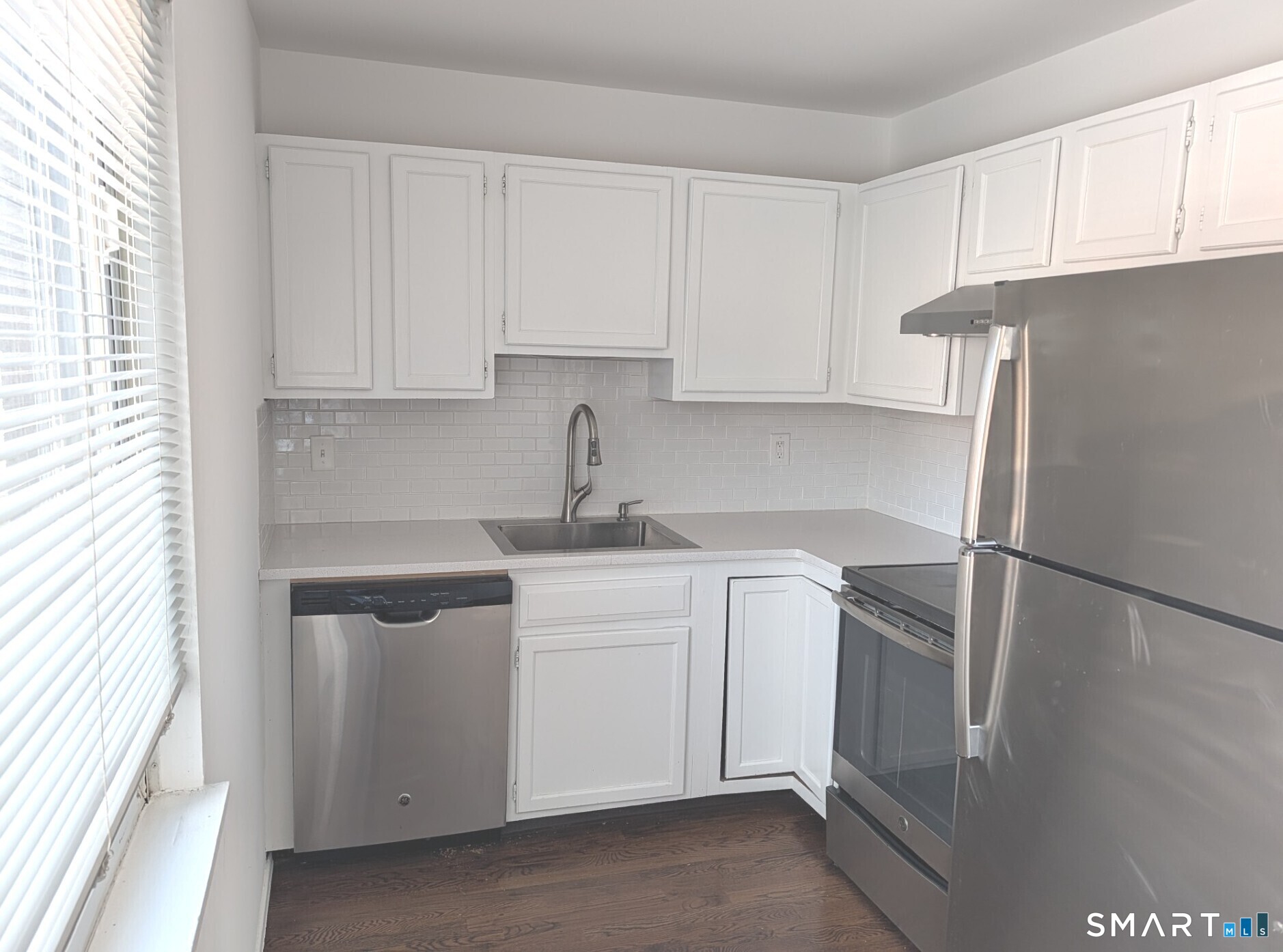 18 Prospect Street, Unit C10 Norwalk, CT 06850 - Photo 5 of 11 a kitchen with a sink and refrigerator