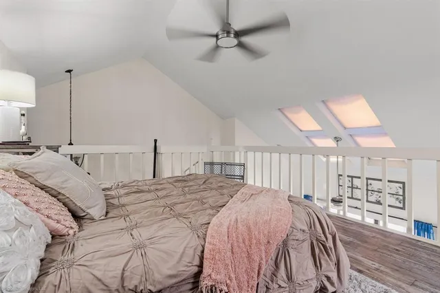 a bed sitting in a bedroom and chandelier