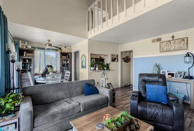 a living room with furniture and wooden floor