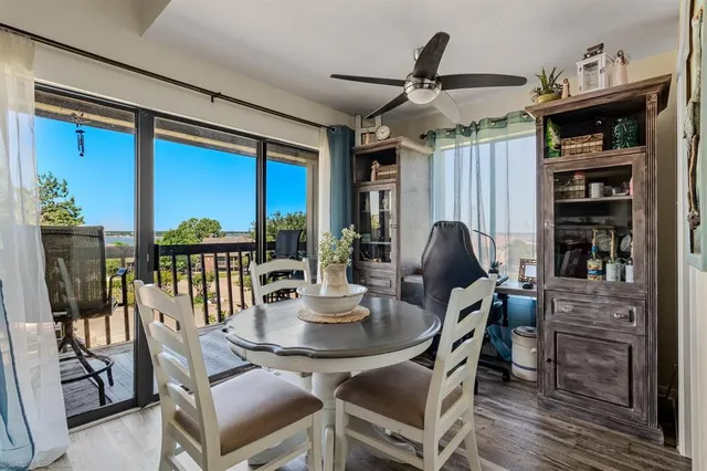 a dining room with furniture window and wooden floor
