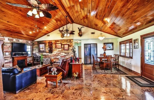 a view of a livingroom with furniture wooden floor and windows