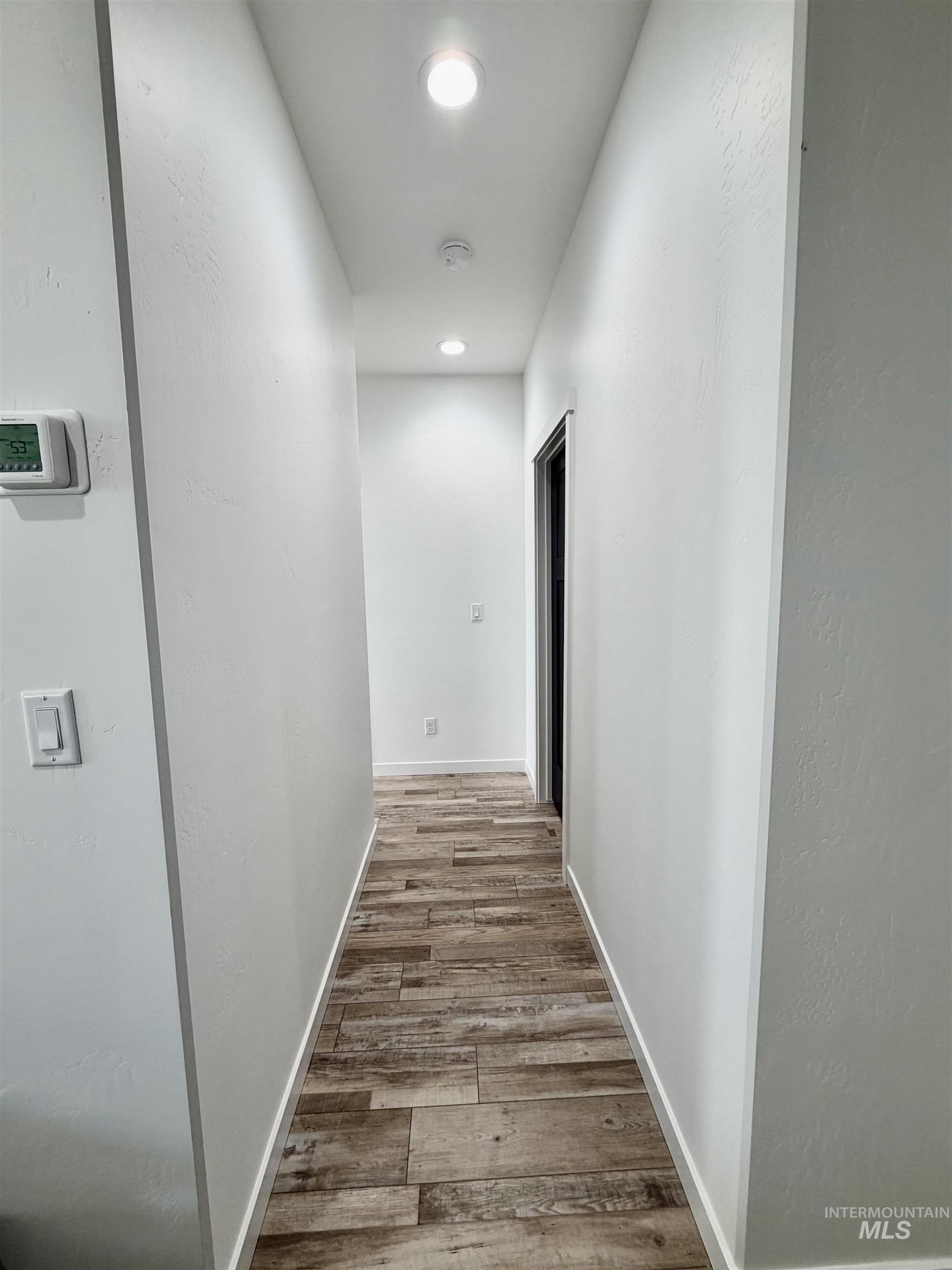 1419 Topaz Rupert, ID 83350 - Photo 13 of 41 Hallway featuring light wood-type flooring, recessed lighting, and a textured wall