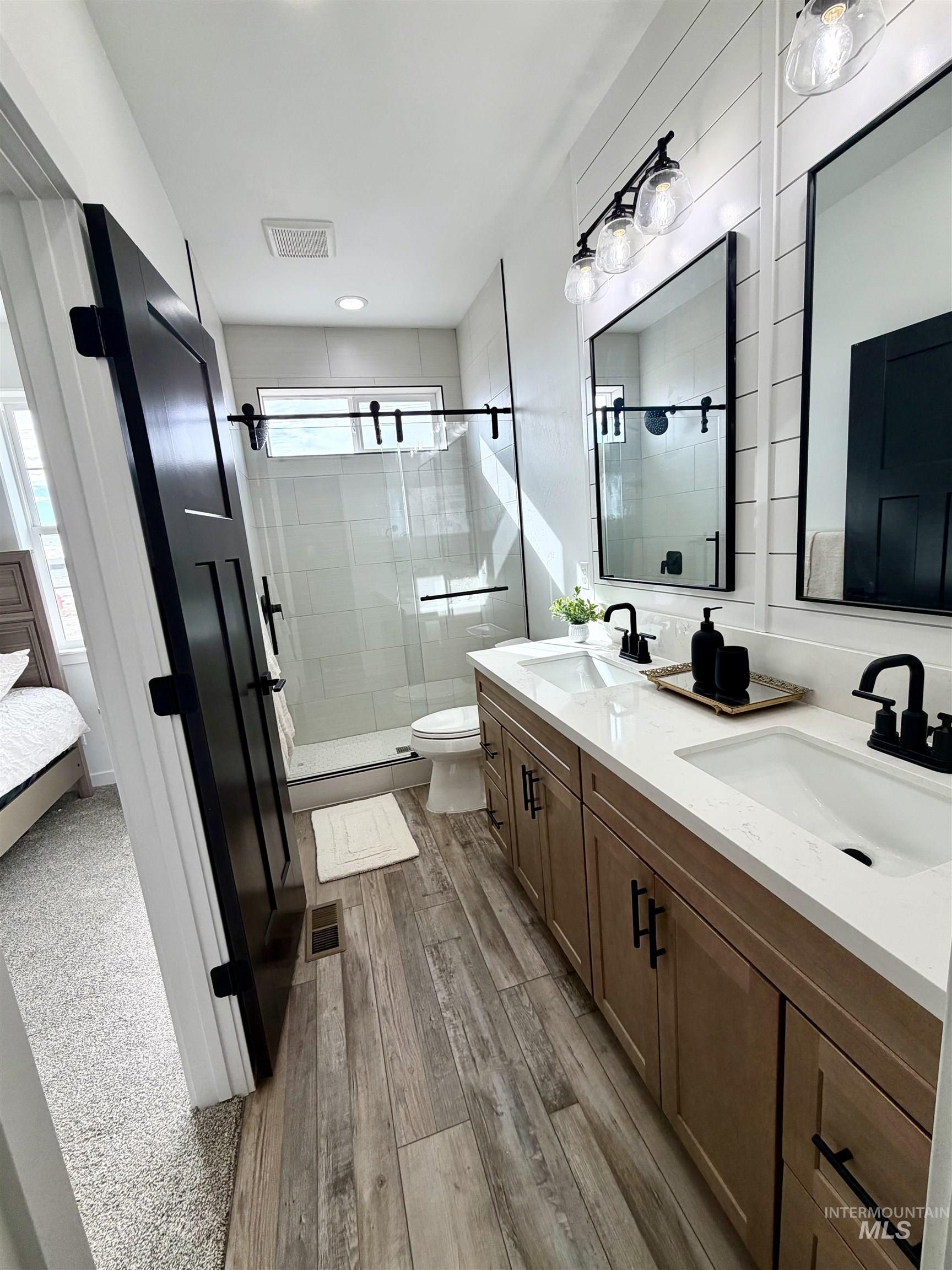 1419 Topaz Rupert, ID 83350 - Photo 23 of 41 Ensuite bathroom featuring a shower stall, double vanity, and light wood finished floors