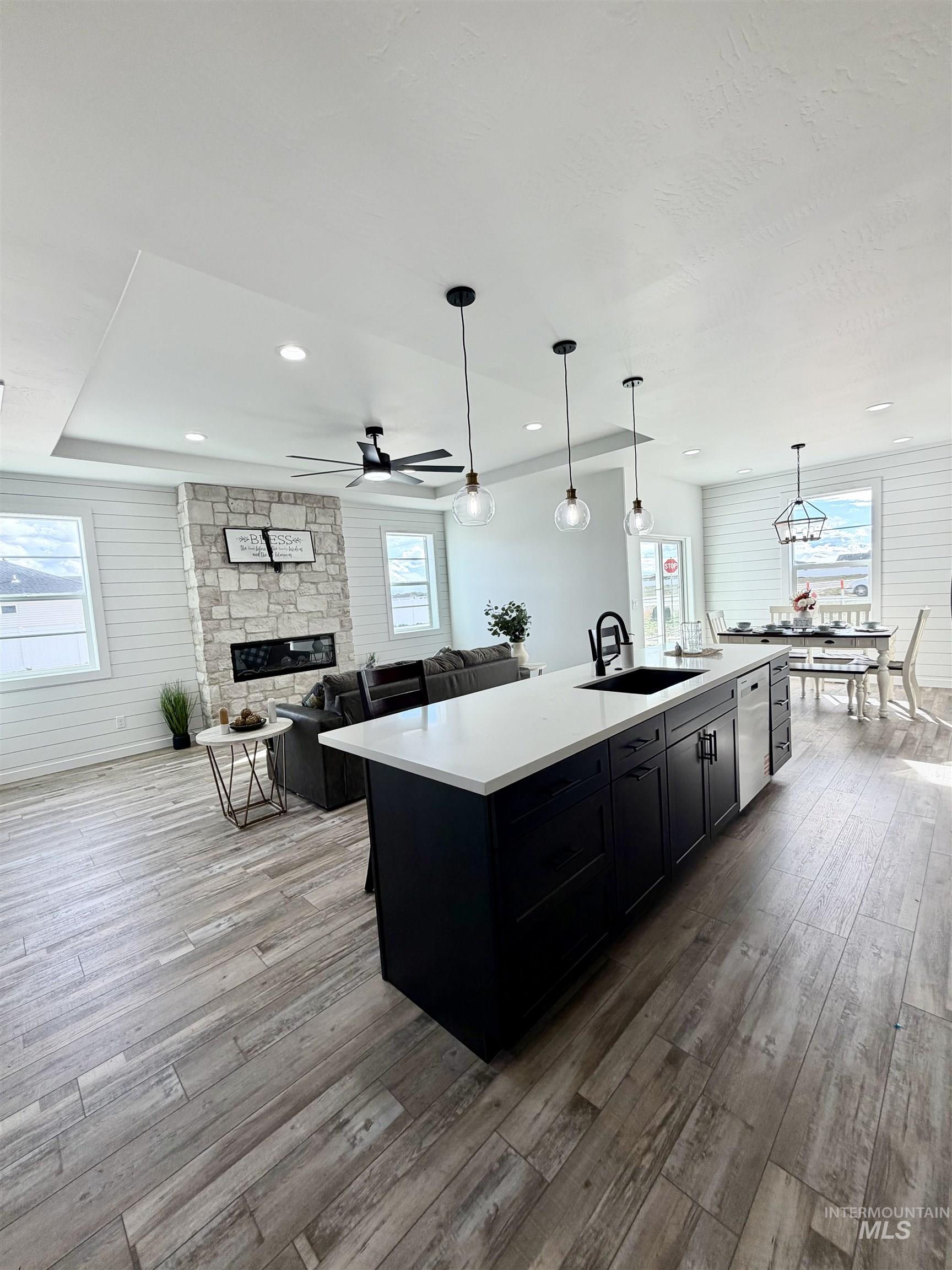 1419 Topaz Rupert, ID 83350 - Photo 41 of 41 Kitchen with open floor plan, a center island with sink, hanging light fixtures, a fireplace, and light wood finished floors