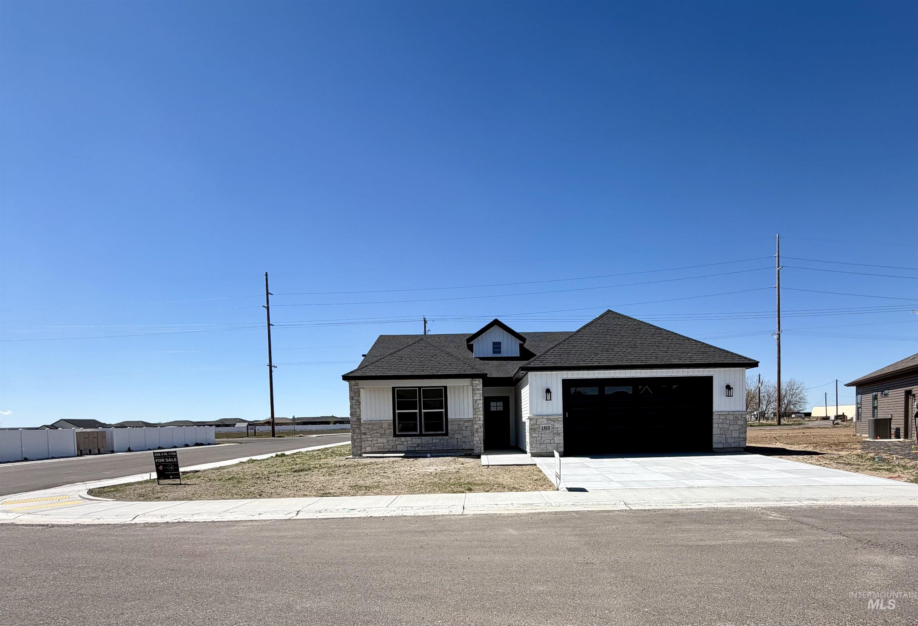 1419 Topaz Rupert, ID 83350 - Photo 33 of 41 View of front of property with stone siding, driveway, a garage, and a shingled roof