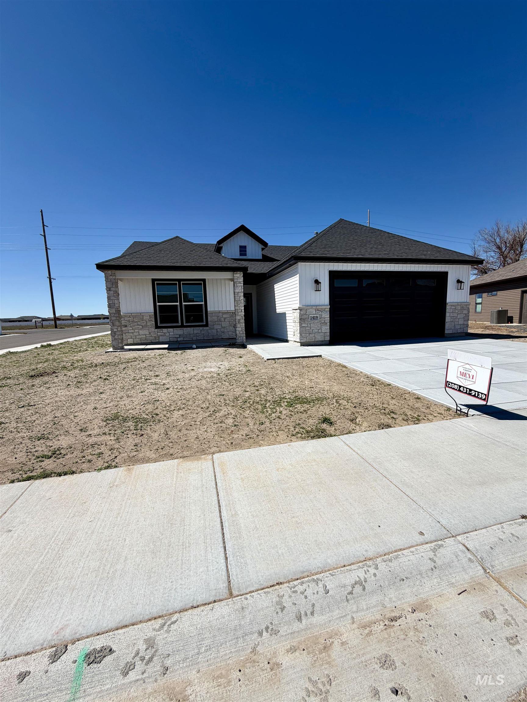 1419 Topaz Rupert, ID 83350 - Photo 35 of 41 View of front of property with stone siding, concrete driveway, and a garage