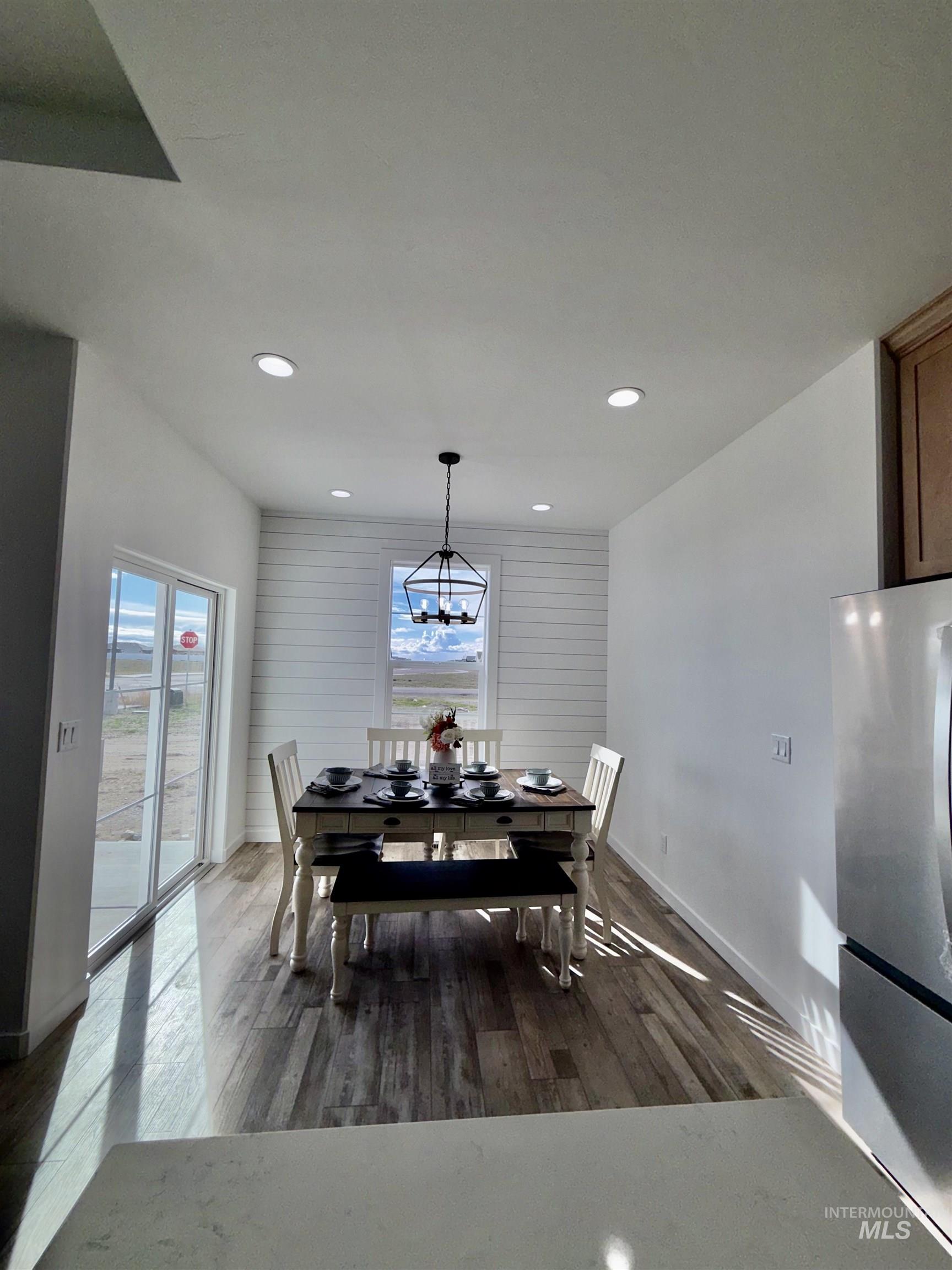 1419 Topaz Rupert, ID 83350 - Photo 8 of 41 Dining space featuring dark wood-style flooring and a chandelier