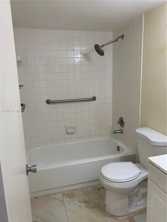a bathroom with a toilet bathtub and shower