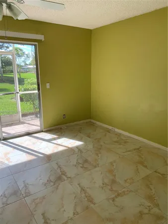 a view of a yellow room with a window