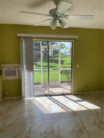 a view of a livingroom with a ceiling fan and a window