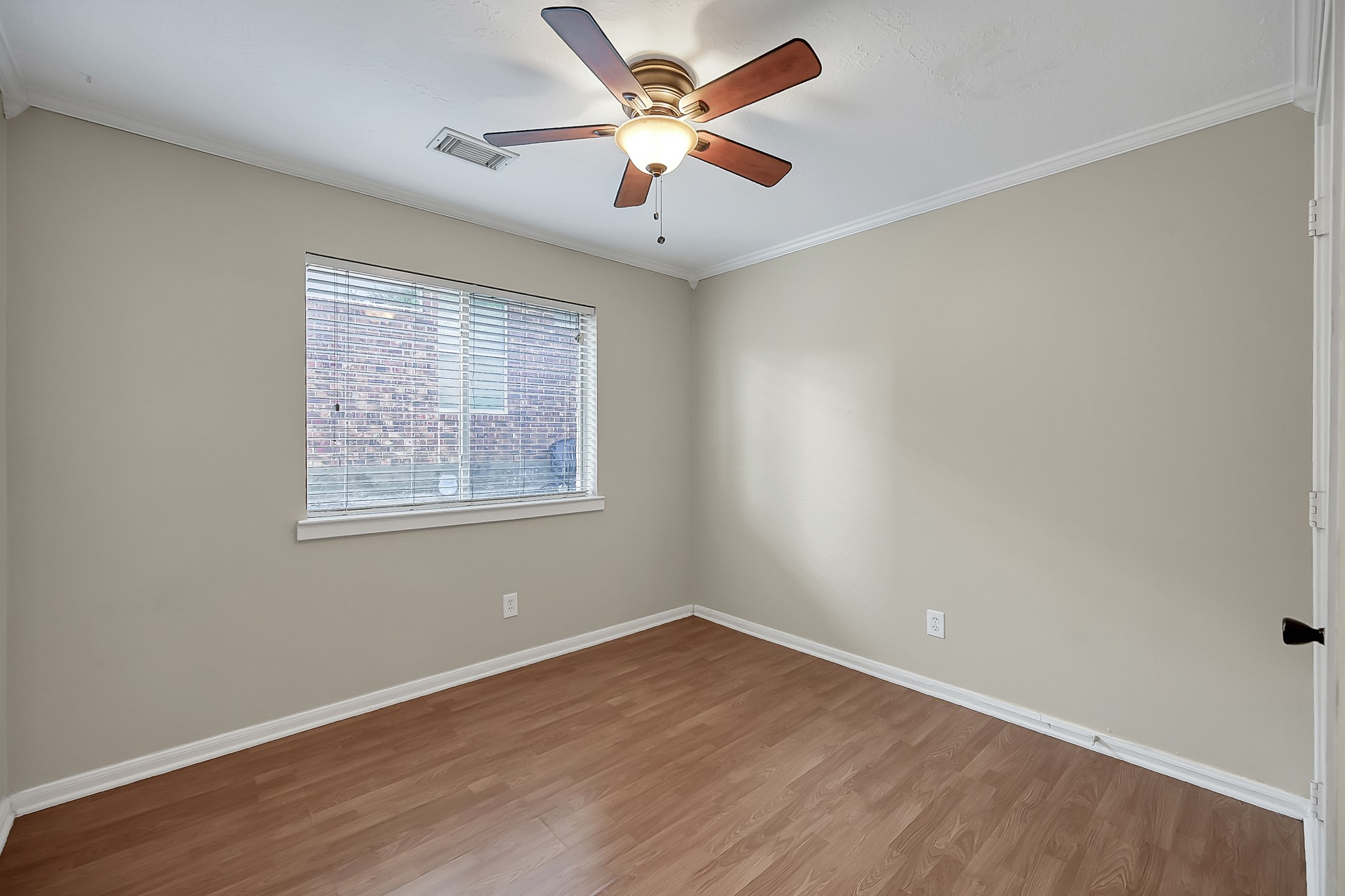 222 Lazy Lane Montgomery, TX 77356 - Photo 14 of 18 an empty room with wooden floor and ceiling fan