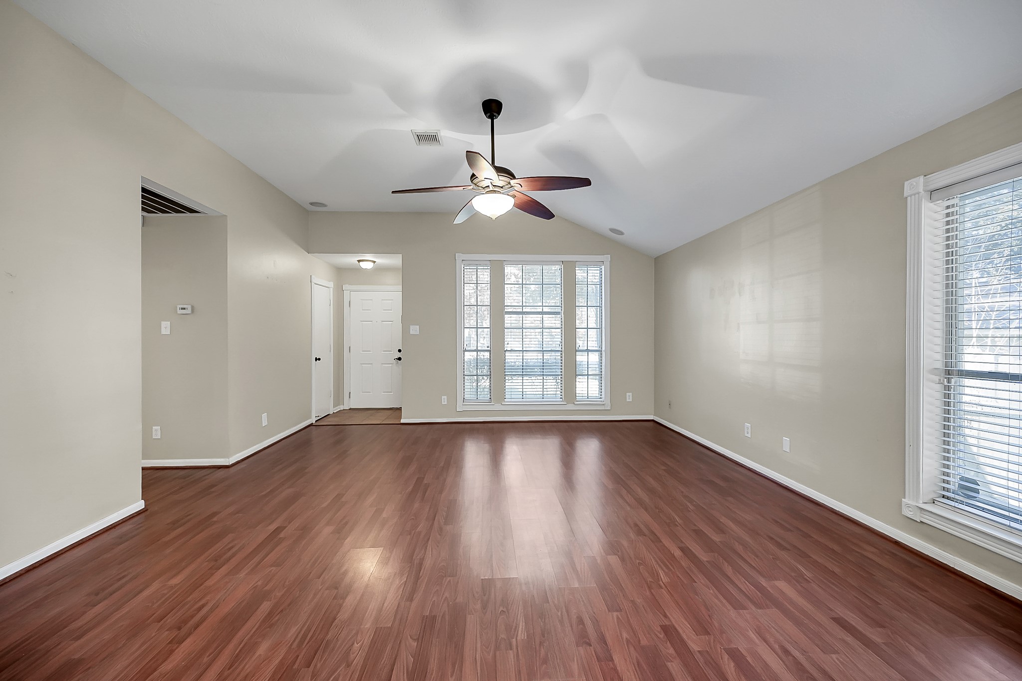 222 Lazy Lane Montgomery, TX 77356 - Photo 5 of 18 a view of an empty room with wooden floor and a window
