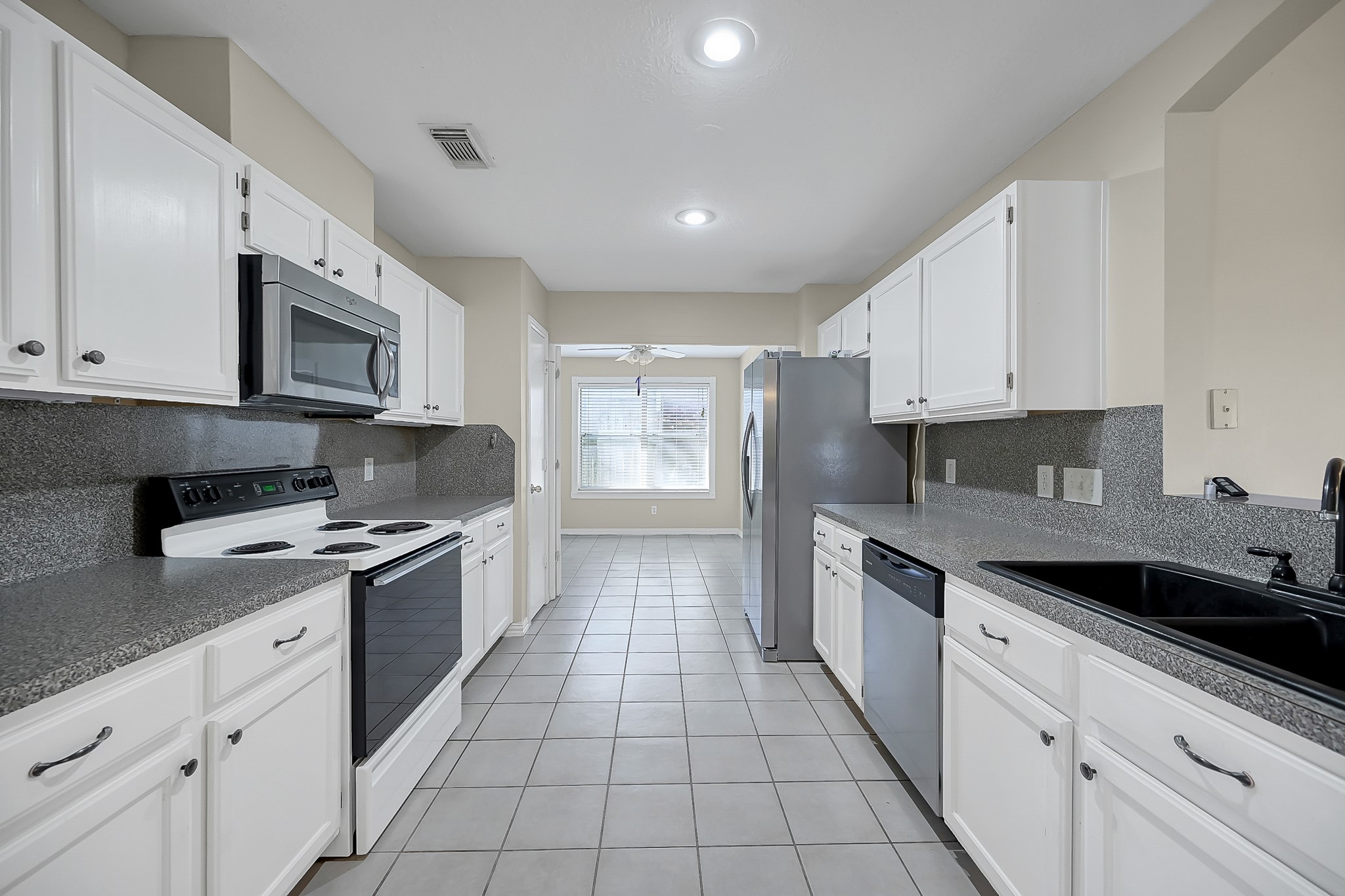 222 Lazy Lane Montgomery, TX 77356 - Photo 7 of 18 a kitchen with stainless steel appliances granite countertop a sink and a stove