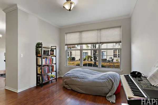 a bedroom with a bed and a book shelf